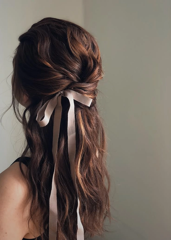 Velvet ribbon half up hairstyle perfect for festive occasions Elegant half-up hairstyle with a velvet ribbon bow for holidays