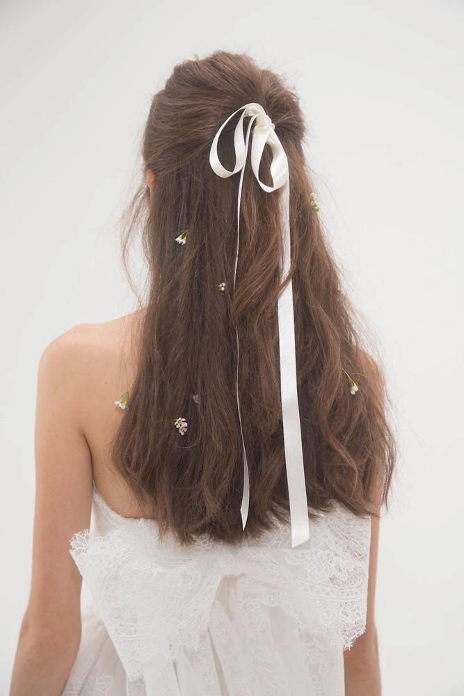 Holiday half up do with velvet ribbon for festive elegance A half up hairstyle with a velvet ribbon, perfect for holiday celebrations