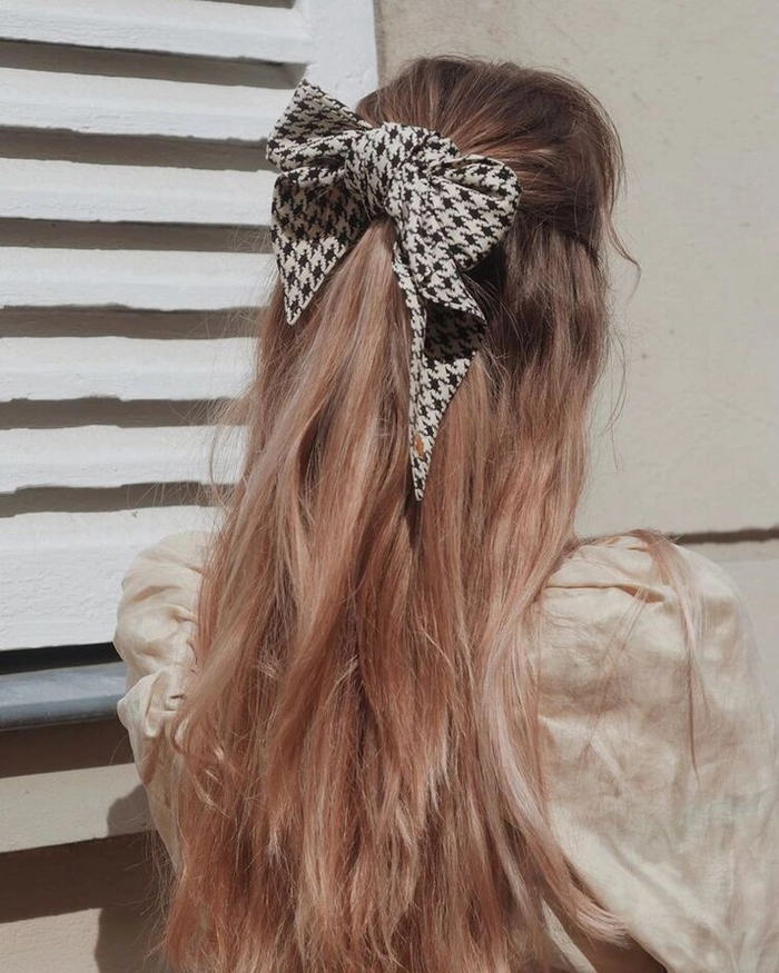 Elegant velvet ribbon half up style for festive occasions Half up hairstyle with a velvet ribbon for holiday celebrations