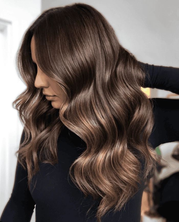 Holiday Warm Hair Color Trend Image 10 Warm holiday hair color trend featuring rich golden and copper tones on shoulder-length waves