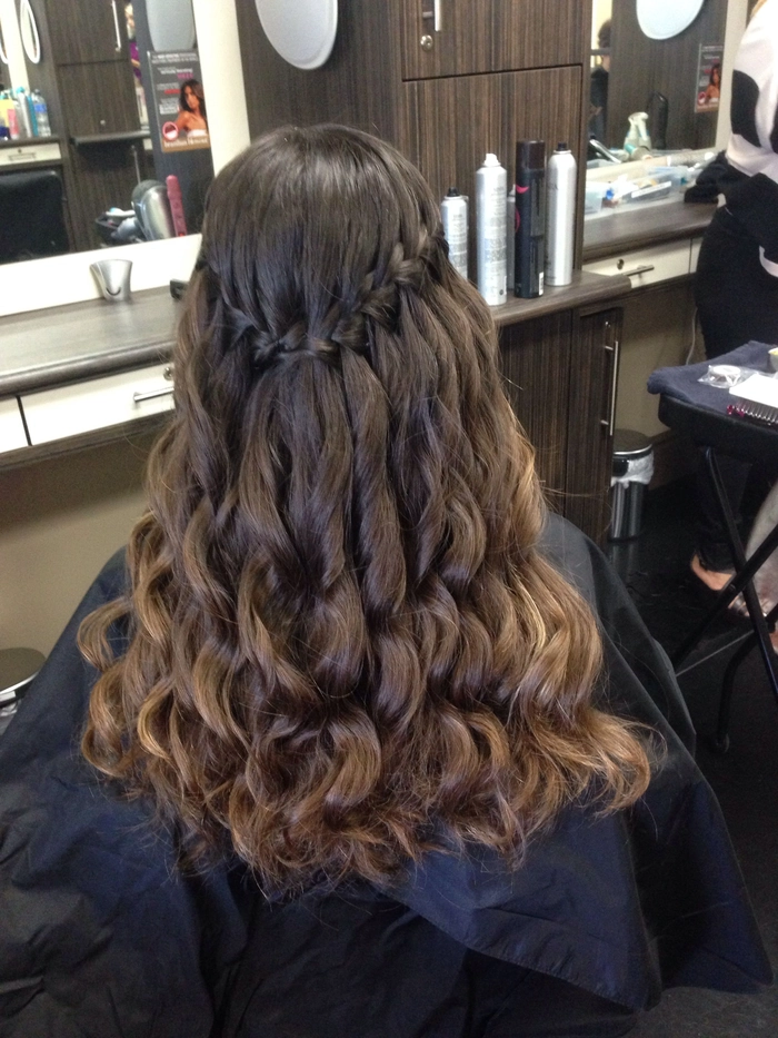 Woman wearing a waterfall braid hairstyle for a daytime holiday event