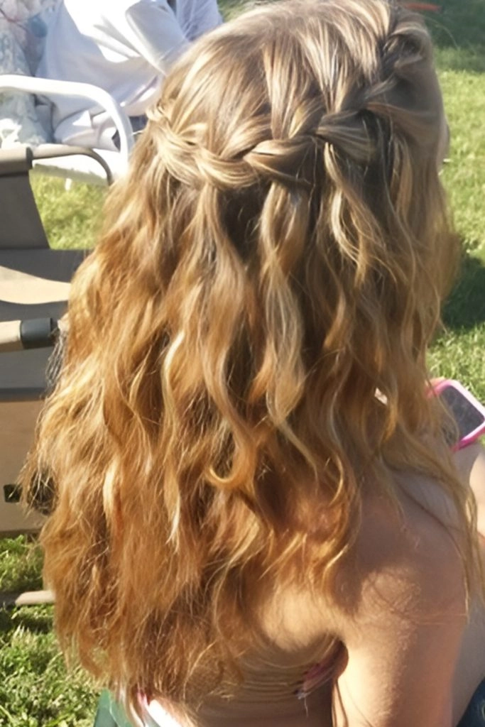 Woman with festive waterfall braid styled for daytime holiday gathering