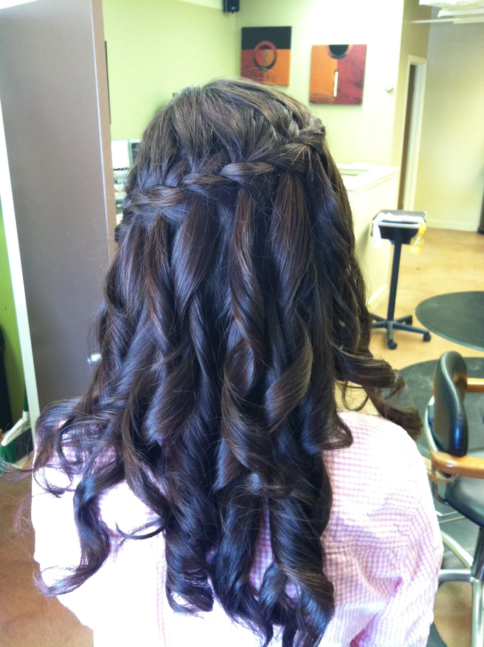 Daytime holiday waterfall braid with soft waves and small floral pins