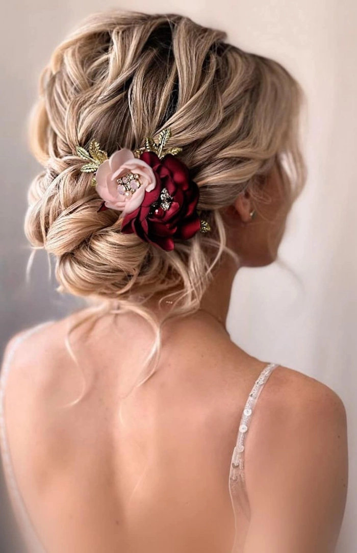 Winter bridesmaid updo with white floral pins and loose curls