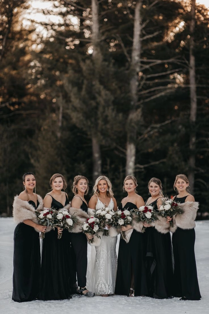 Elegant winter bridesmaid updo adorned with floral pins