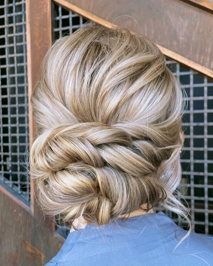 Winter bridesmaid updo with floral pins for a holiday celebration