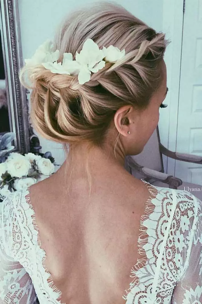 Winter bridesmaid updo adorned with silver and white floral pins for a holiday wedding