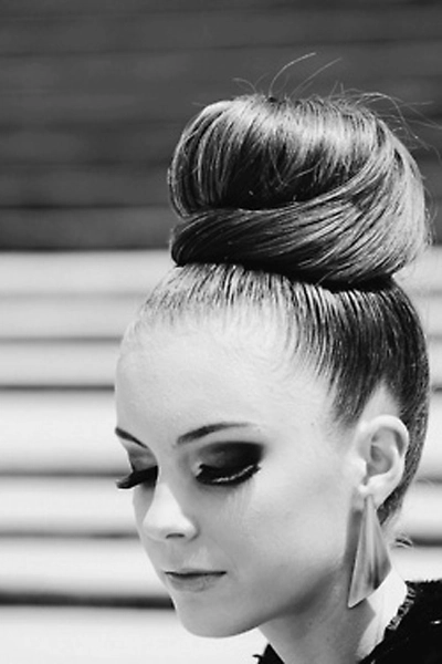 Birthday party hairstyle featuring a smooth high top knot with sleek finish Elegant high sleek top knot hairstyle for a birthday party