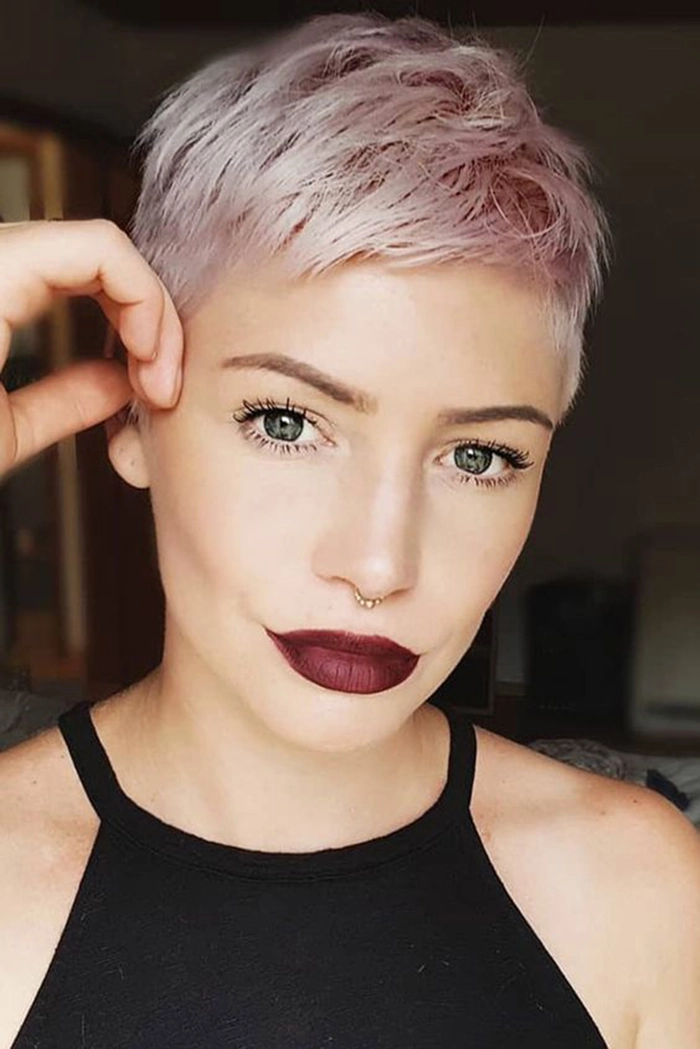 Edgy Clubbing Pixie Hairstyle with Glitter Accents Woman with short pixie cut styled with volume and sparkle for a night out