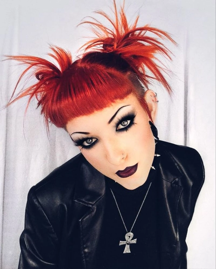 Two high space buns styled with metallic accessories for an edgy clubbing look