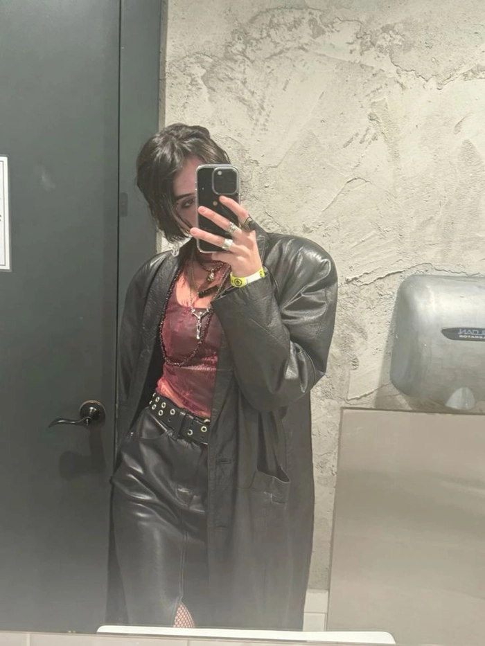 Edgy clubbing space buns hairstyle paired with a bold outfit