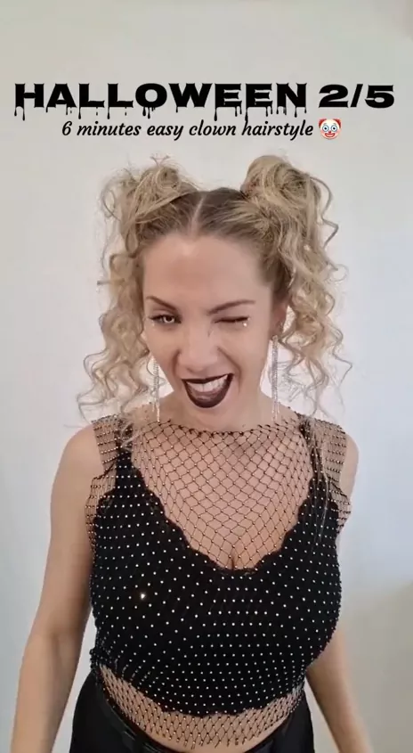 Edgy clubbing space buns paired with bold makeup and a dark outfit