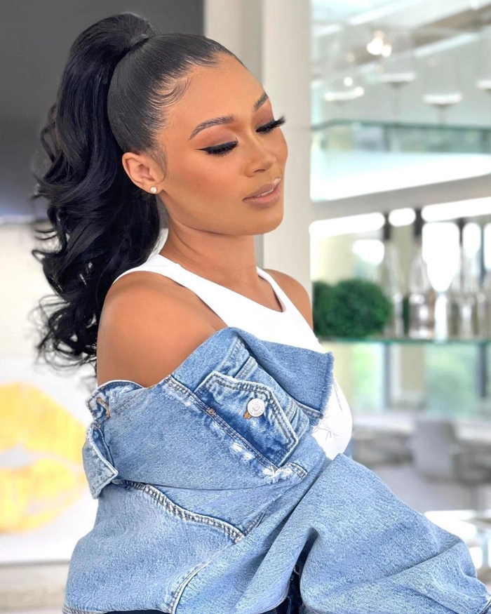Women in cocktail attire with sleek high ponytails posing for a party hairstyle look