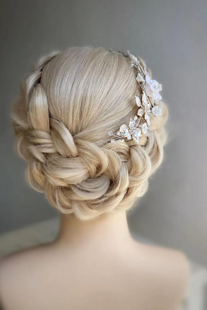 Elegant cocktail party hairstyle with braided halos complementing a formal dress