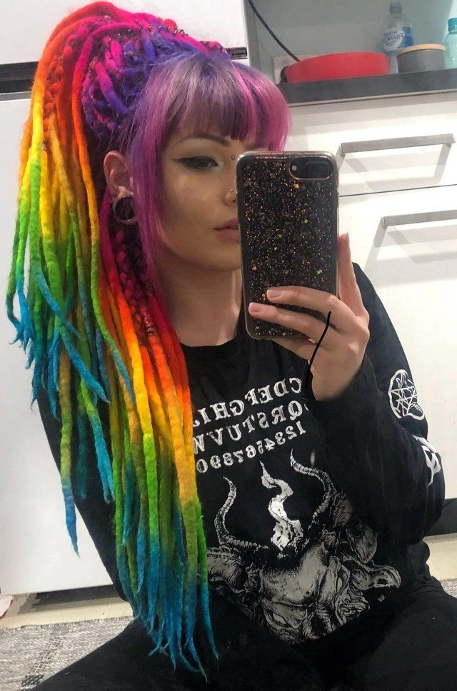 Cyberpunk festival hairstyle with vibrant neon hair extensions glowing under party lights