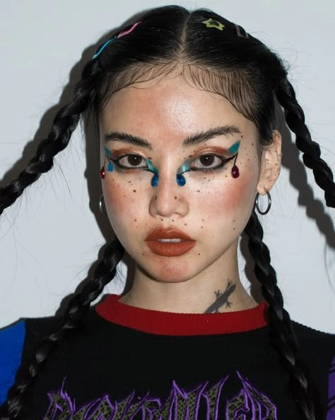 Edgy festival hairstyle inspiration for alternative teens looking to stand out Alternative teen with bold spiked hair and colorful dye at a lively music festival