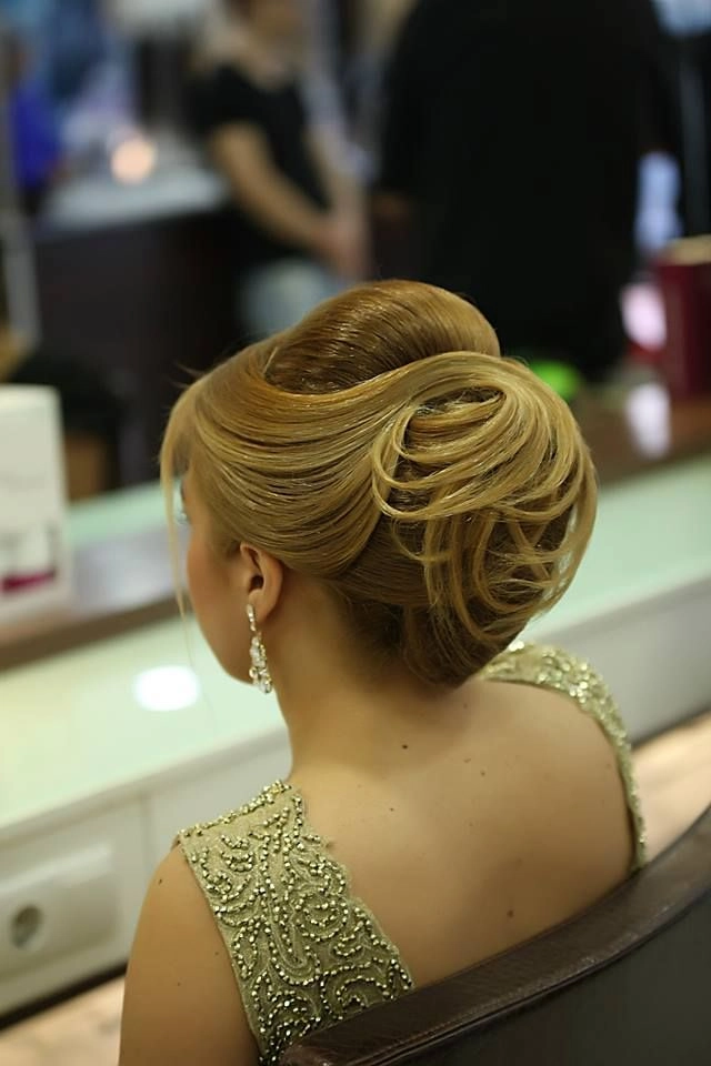Elegant evening bun styled with twists on very long hair for a party hairdo