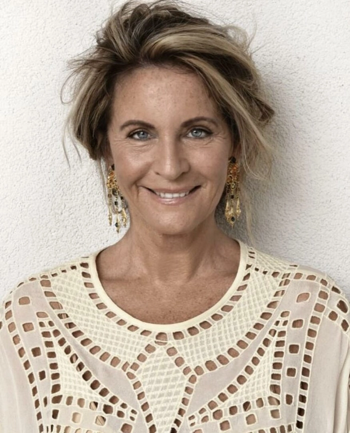 Sophisticated updo hairstyle perfect for women over forty attending evening parties Elegant evening updo for women over forty with soft curls and volume at the crown