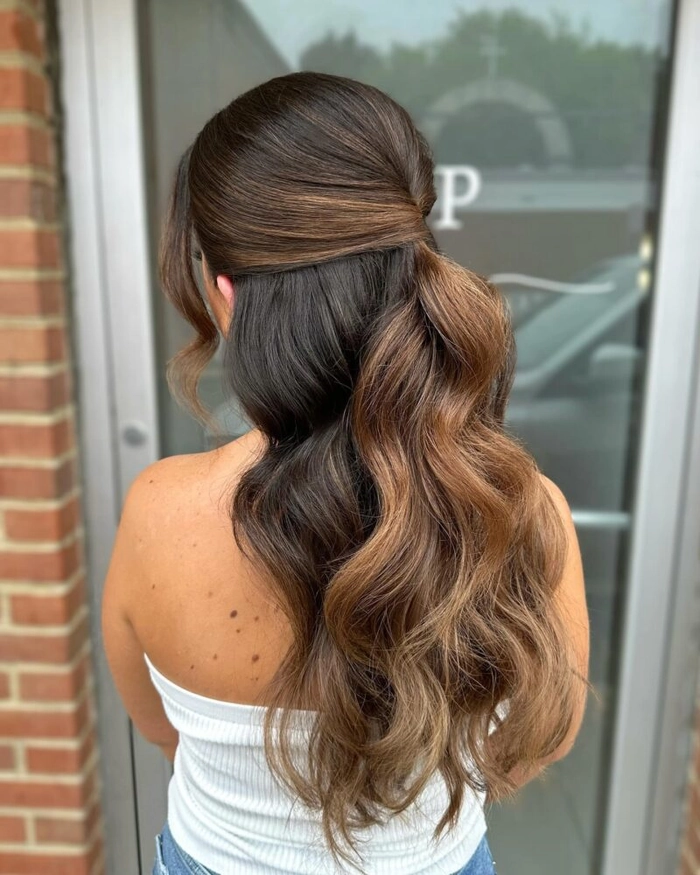 Elegant romantic half up style for engagement party celebrations Romantic half-up engagement party hairstyle with soft curls and floral accents