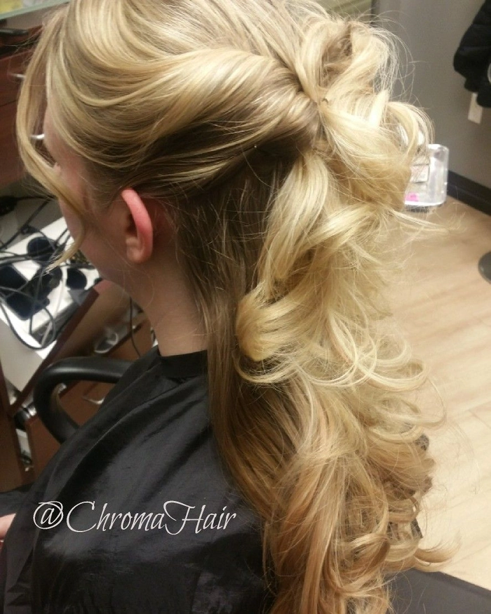 Engagement party romantic half-up style with twisted details and subtle volume Romantic half-up hairstyle with soft curls and delicate accessories for an engagement party