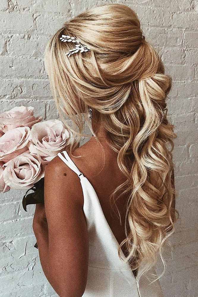 Engagement party romantic half up style featuring elegant hair accessories Romantic half-up engagement party hairstyle with soft curls and delicate accents