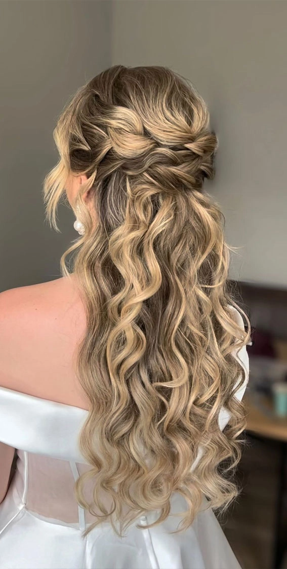 Elegant half-up style perfect for a romantic engagement celebration Romantic half-up engagement party hairstyle with soft waves and delicate accessories