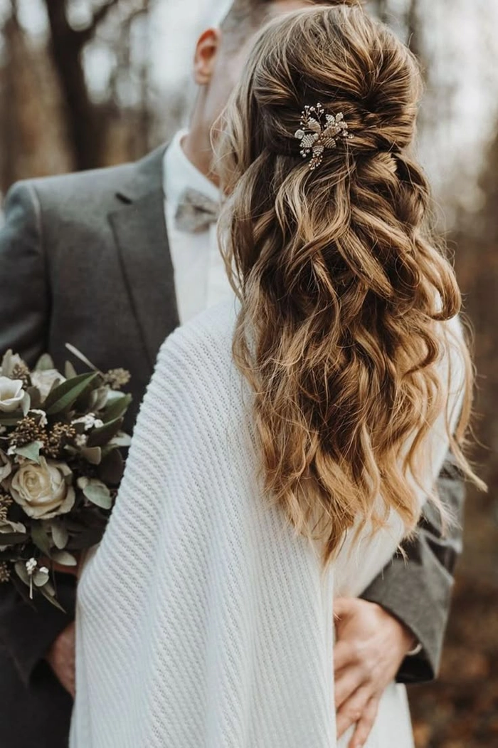 Elegant engagement party half-up style featuring delicate details and romantic flair Romantic half-up engagement party hairstyle with soft curls and floral accents