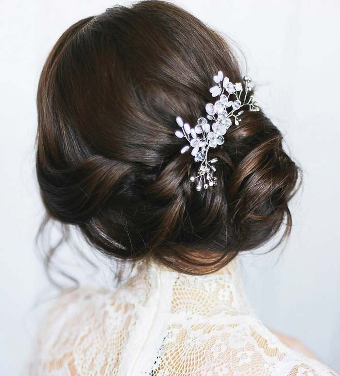 Elegant updo hairstyle paired with a high neck velvet gown for a party look