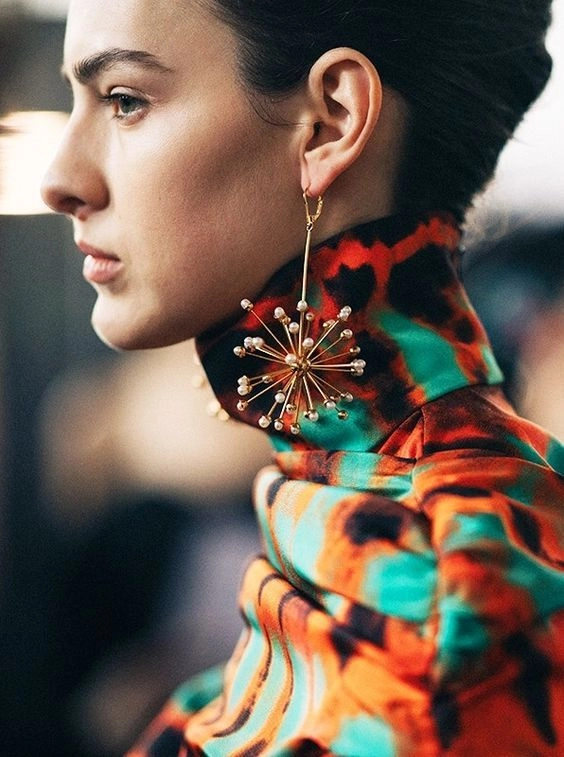 Chic evening updo with sparkling statement earrings perfect for party glamour