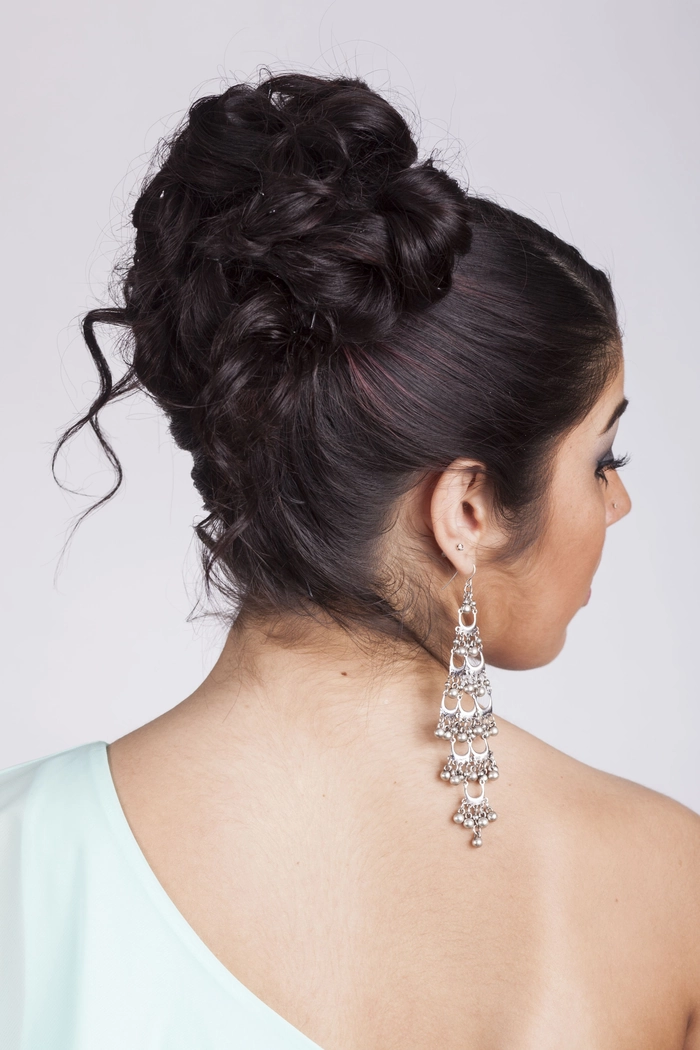 Elegant evening updo with sparkling statement earrings for a party