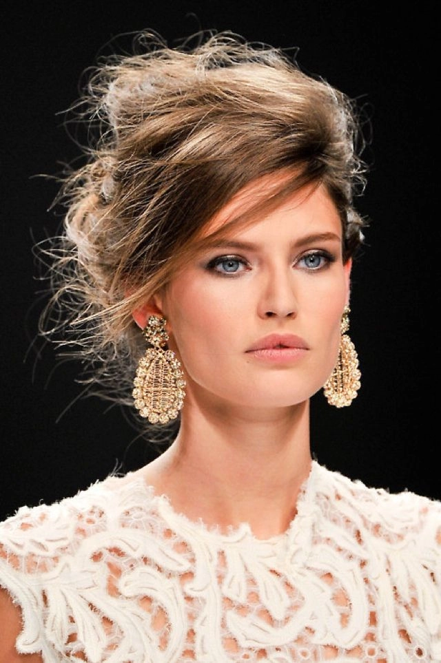 Elegant evening updo hairstyle featuring statement earrings for a party look