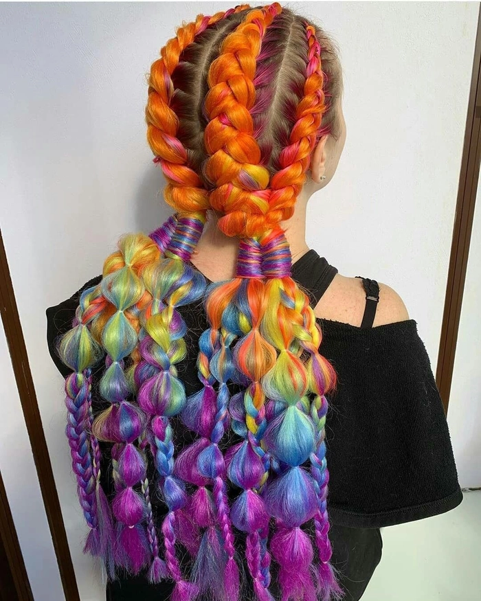 Festival braids with hidden rainbow underlights in a stylish party hairstyle