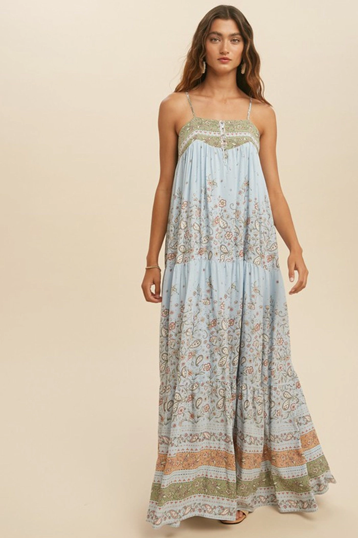 Flowy bohemian maxi dress paired with festival-inspired loose waves and floral hair accessories