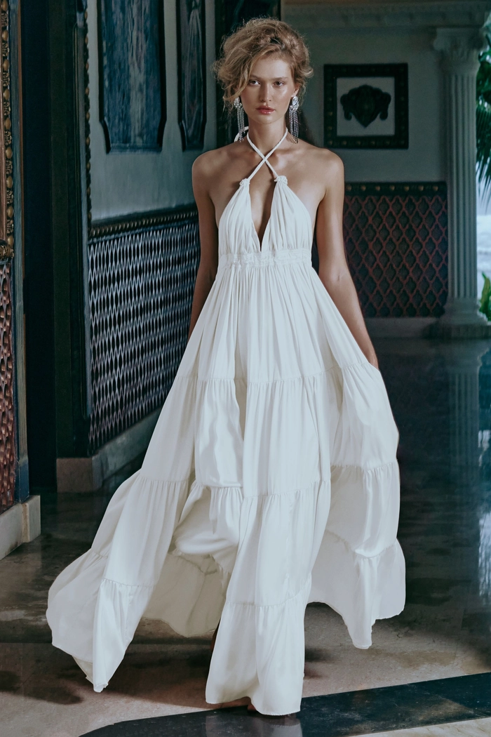Flowing bohemian maxi dress with festival-inspired braided hairstyle