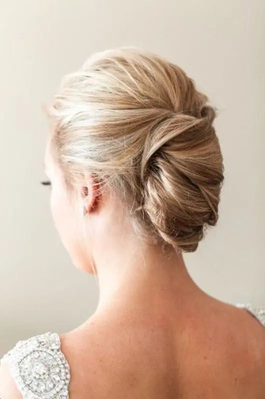 A chic french twist updo perfect for formal party wear Elegant party french twist updo hairstyle complementing a formal gown
