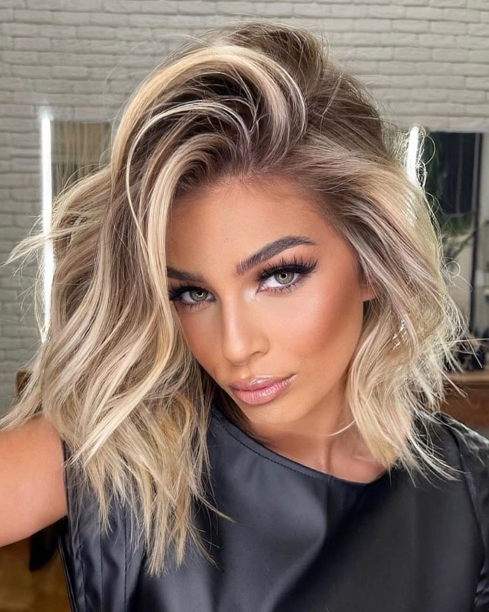 Freshly highlighted blonde hair styled in an elegant gala updo