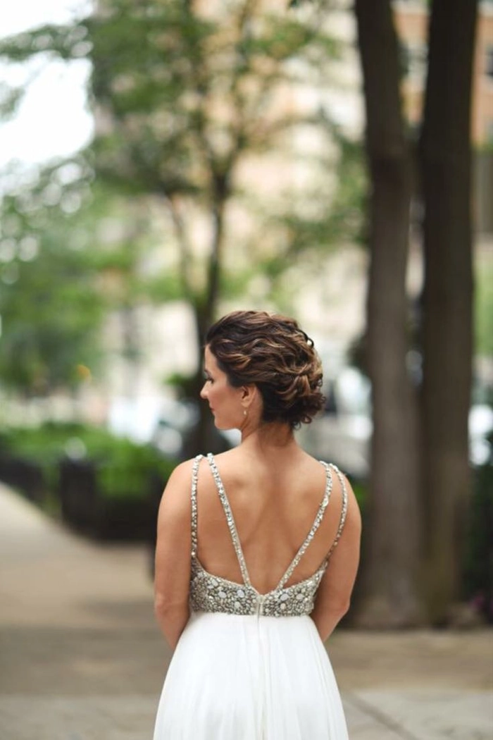Elegant gala updo hairstyle paired with backless evening wear for a party