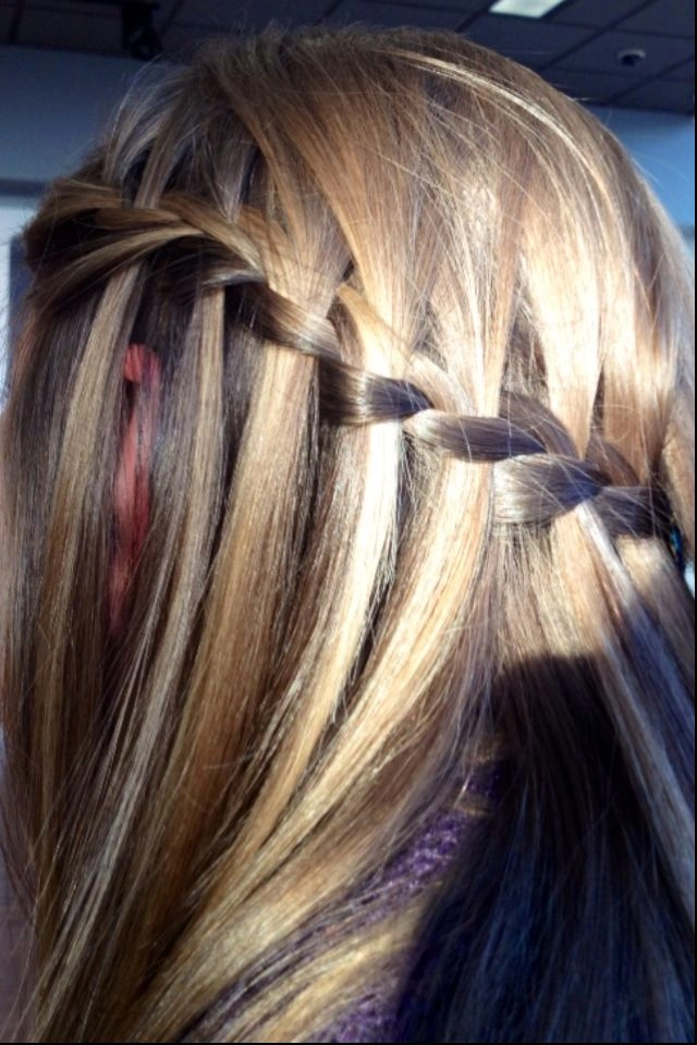 Elegant gala waterfall braid hairstyle on medium length hair with soft waves and delicate accessories
