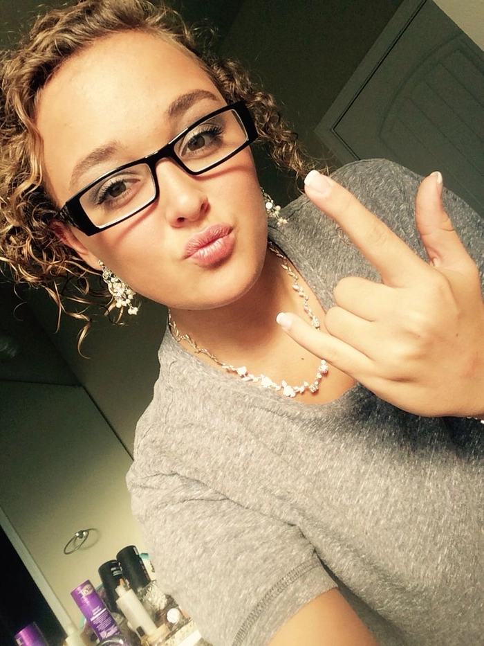 Elegant updo hairstyle paired with glasses for a formal dinner party