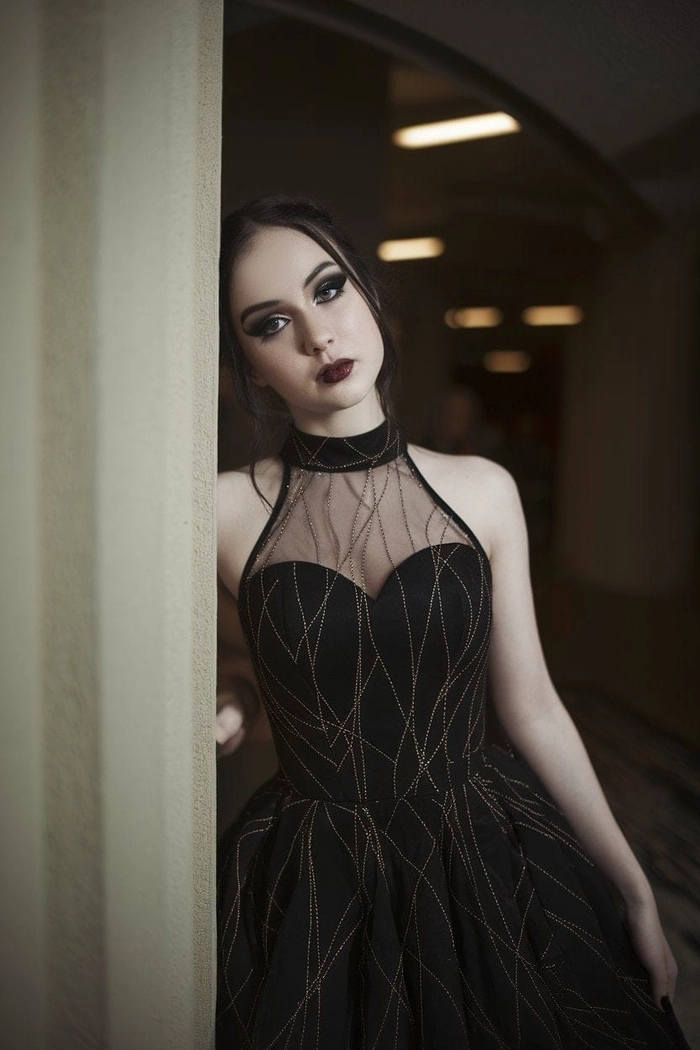 A gothic prom hairstyle featuring intricate braids and dark rose accessories for a dramatic party look