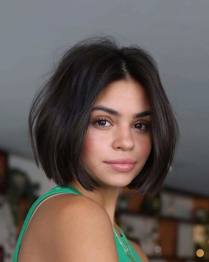 Holiday party hairstyle featuring a straight blunt bob with shimmering accessories