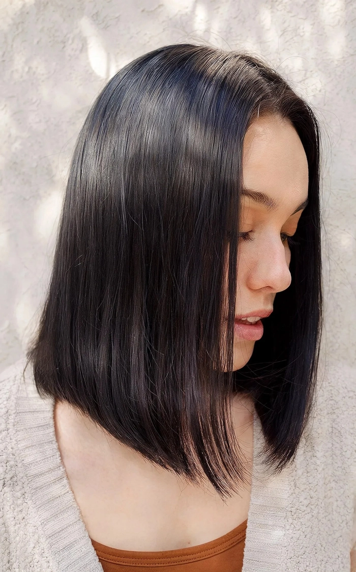 A straight blunt bob styled with festive holiday party accessories
