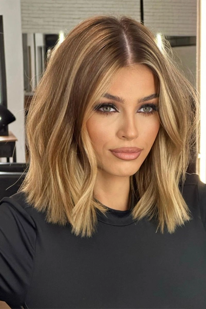 Straight blunt bob styled for holiday party with sleek shine and accessories