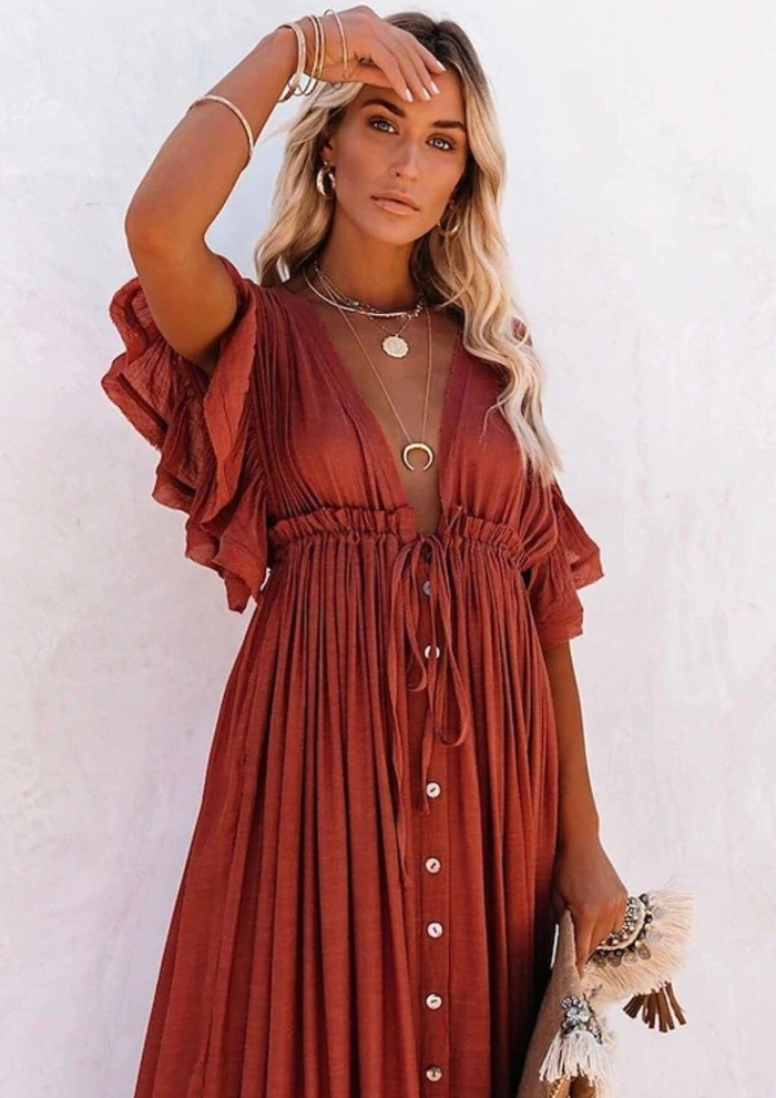 Festival hairstyle with braided crown and soft curls complementing a flowy bohemian maxi dress