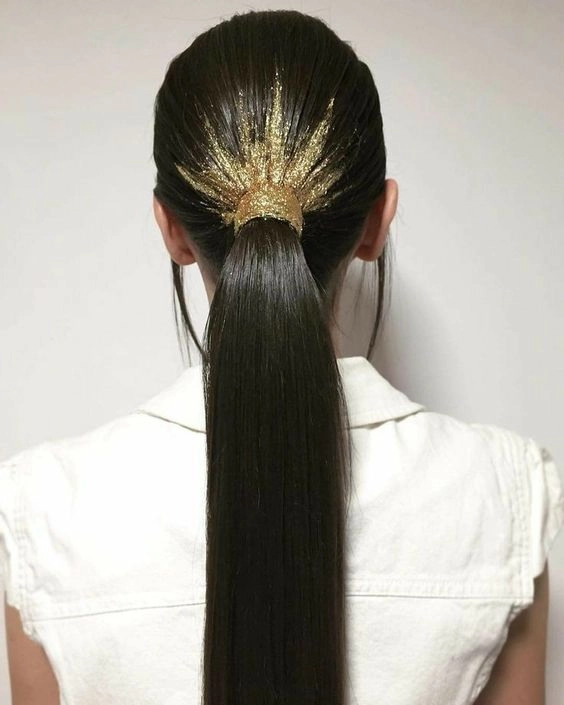 Elegant New Year's Eve hairstyle complementing a silver metallic mini dress with glamorous waves and sparkling accessories