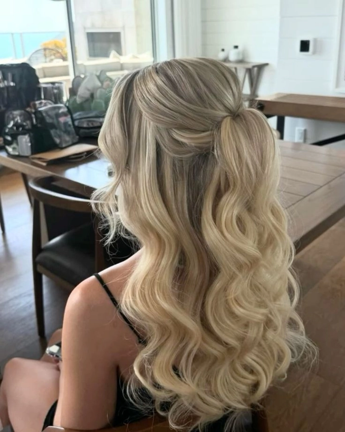 Elegant prom hairstyle for high school seniors with soft waves and a sparkling hair accessory