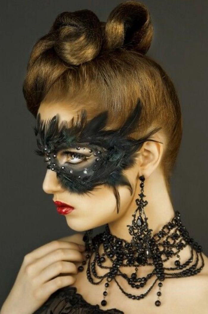 Elegant updo paired with feather mask for a glamorous masquerade ball look Hairstyle that complements a feathered masquerade mask at a party