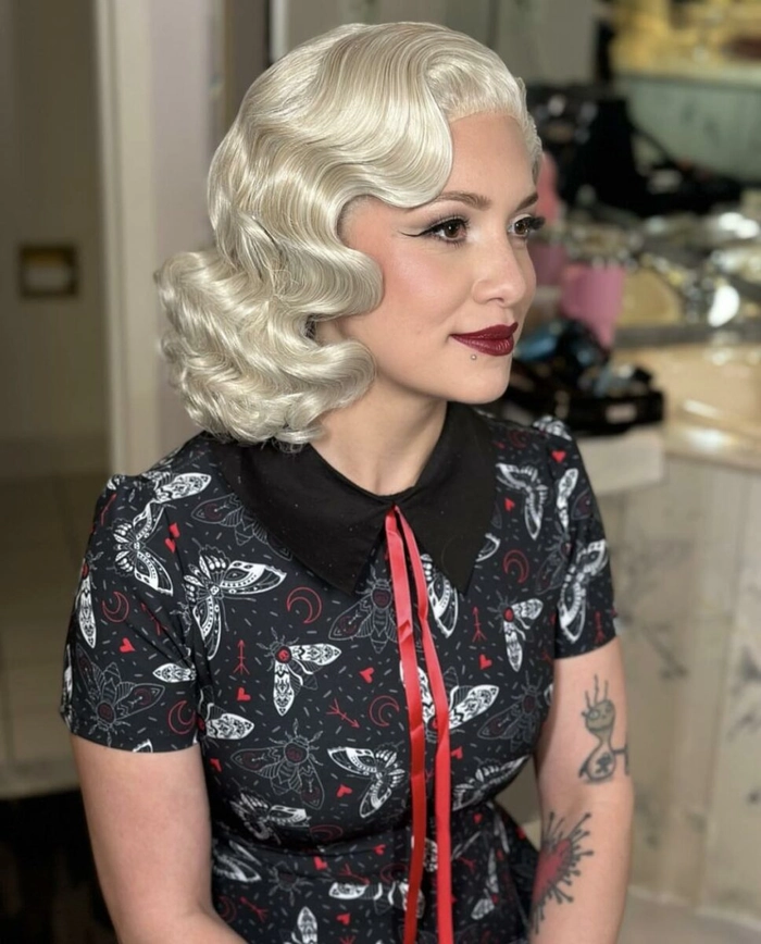 Masquerade Ball Vintage Finger Waves Hairstyle Vintage finger waves styled for a masquerade ball, elegant party hairstyle with feathered headpiece