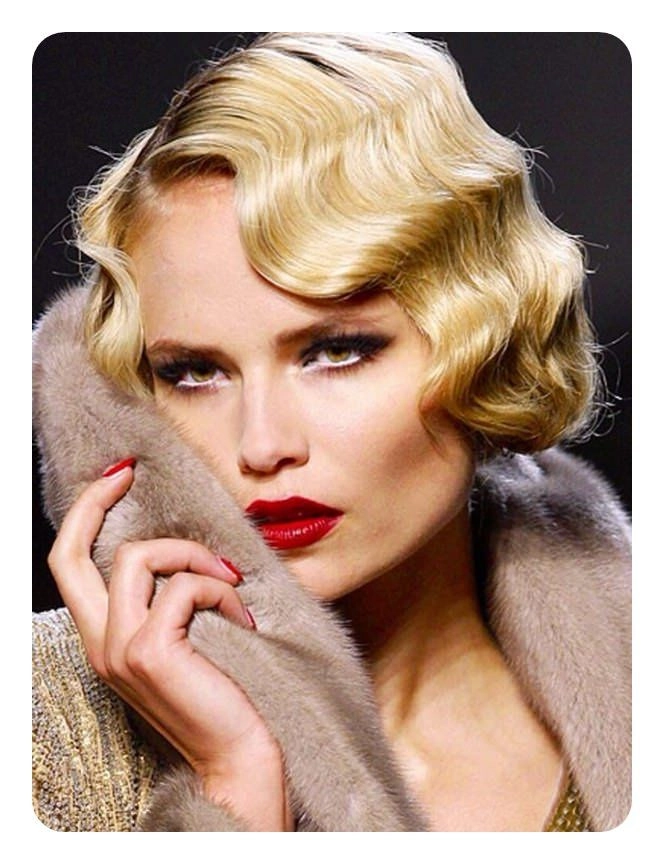 Vintage finger waves and masquerade mask for a glamorous party look A woman with vintage finger waves hairstyle wearing a masquerade mask at a party