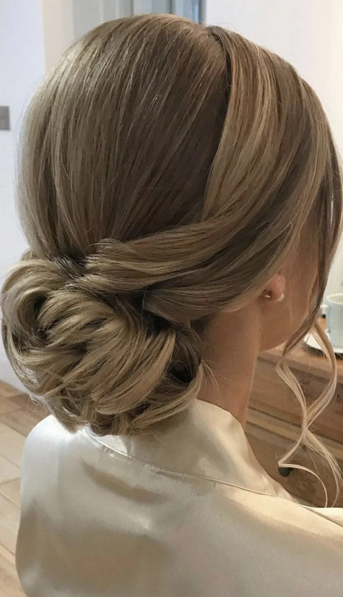 Sleek minimalist party bun hairstyle perfect for formal occasions minimalist sleek low bun with subtle side part for a formal event